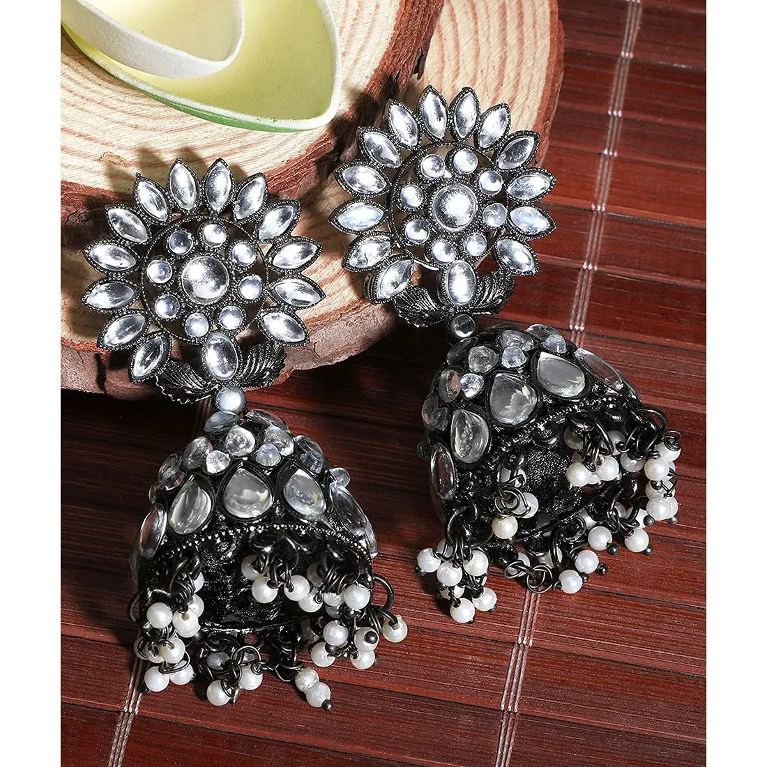 Yellow Chimes Black Gun Plated Studded Stones Flower Design Traditional Jhumka Earrings for Women And Girls, Medium (Model Number: YCTJER-87STLFJH-WH)